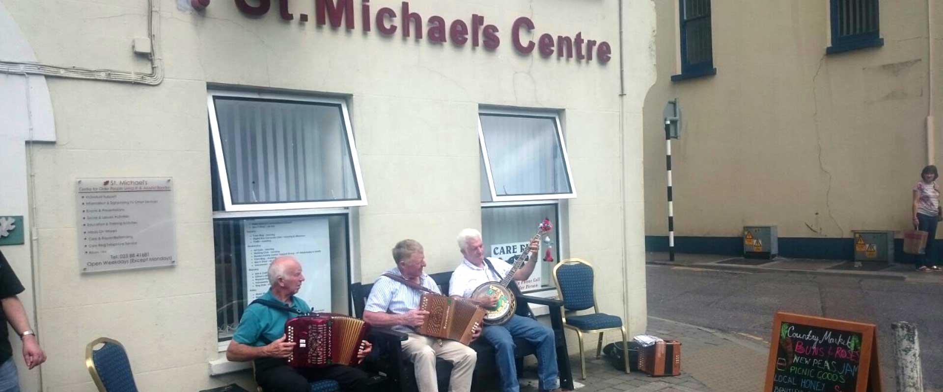 Musicians playing outside the original St Michael’s Centre building
